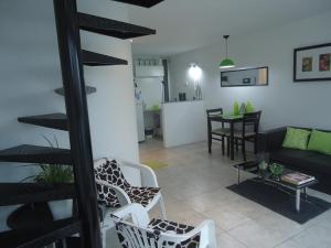 a living room with a couch and chairs and a table at Departamento Calle 46 in La Plata