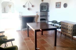 a living room with a wooden table and chairs at Luxurious Villa in Loja with pool in Loja