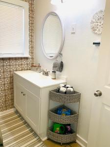 a bathroom with a sink and a mirror at Cozy Home Away From Home in Mojave +16 photos