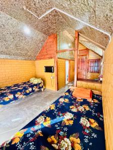 a large room with two beds in a room at Cozyo Stays Boutique Home Jowai in Jowai