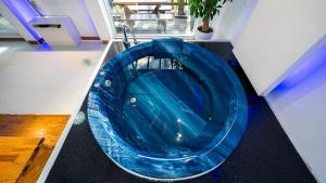a large blue bath tub in a room at Hoengseong Couple Star in Porest Pension in Hoengseong