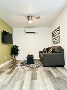 a living room with a couch and a ceiling fan at Amazing Cozy Guest House in Mojave
