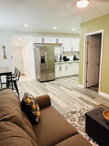 a living room with a couch and a kitchen at Amazing Cozy Guest House in Mojave