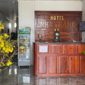 a hotel entrance with a clock and a refrigerator at Nha Trang Homestay Đồng Nai in Tân Phú
