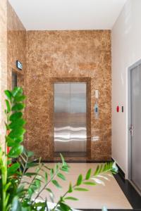 a metal elevator in a room with a brick wall at Greenview City Hotel in Da Lat