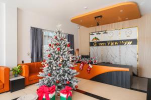 a christmas tree in the middle of a room at Greenview City Hotel in Da Lat +70 photos