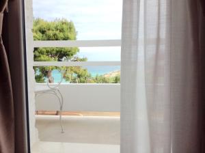 a window with a view of the ocean at Playa del Mar - Adults Only in Monopoli