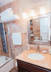 a bathroom with a sink and a mirror at DC 2BD and 1BA Condo w Parking 10 min walk to metro in Washington