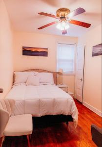 a bedroom with a bed and a ceiling fan at DC 2BD and 1BA Condo w Parking 10 min walk to metro in Washington