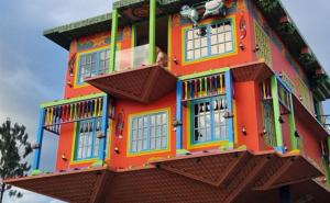 a large colorful building with windows on top of it at Casa Custodia in Ráquira +17 photos