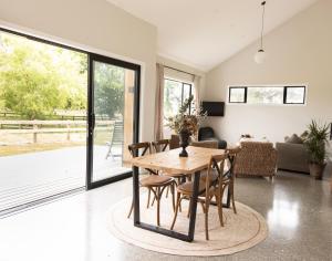 a living room with a wooden table and chairs at The Gatehouse in Clevedon