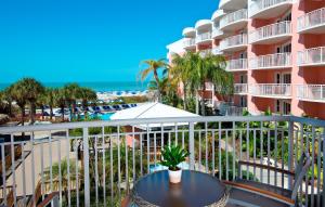 a balcony with a table and a view of the beach at Beach House Suites by the Don CeSar in St. Pete Beach