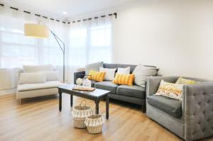 a living room with a couch and a table at Centrally Located Charming LA Home with Food Scenes in Monterey Park