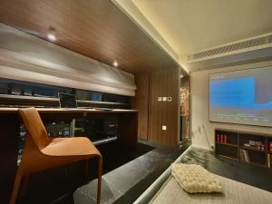 a living room with a television and a desk and a chair at Lucky Jili in Chengdu