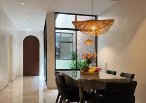 a dining room with a table and chairs at Brickyard at 6 in Ipoh
