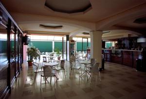 a dining room with tables and chairs in a restaurant at Hotel Belvedere in Lanusei