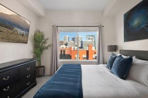 a bedroom with a large bed and a window at Convention Ctr - Stylish 2BD,2BA with Pool,Gym and Hot tub in Salt Lake City