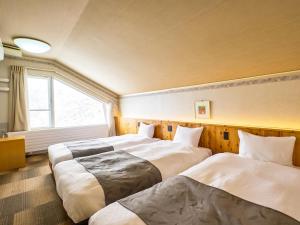 Postel nebo postele na pokoji v ubytování Hotel Abest Hakuba Resort + 37 fotografií