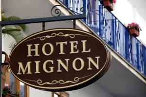 a sign for a hotel mertonostory on a building at Hotel Mignon Meublè in Sorrento