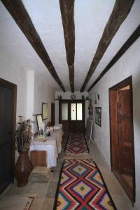 a room with two beds and a ceiling with a rug at Beymelek Tas Evler in Demre