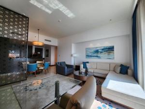 a living room with a couch and a table at Noya luma, yas island in Yas Island