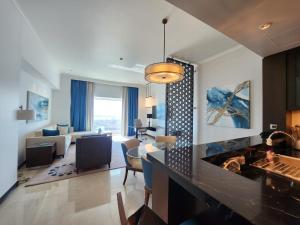 a living room with a fireplace and a living room with a couch at Noya luma, yas island in Yas Island