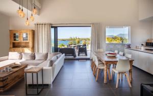 a living room with a white couch and a table at Modern Penthouse - Sunset, Jacuzzi & Sea Views in Tamarin