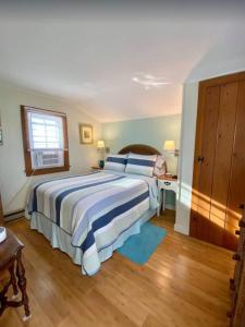 a bedroom with a bed with blue and white sheets at North Truro Pet-friendly home near Secluded Beach in Provincetown