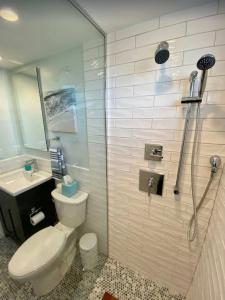 a bathroom with a toilet and a sink and a shower at North Truro Pet-friendly home near Secluded Beach in Provincetown +14 photos