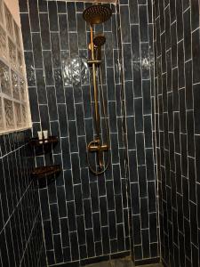 a shower in a bathroom with black tiled walls at Banan Beach in Ras al Khaimah +187 photos
