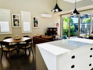 a kitchen with a white island in a living room at Haven on Hunter Lux Townhouse in Mansfield