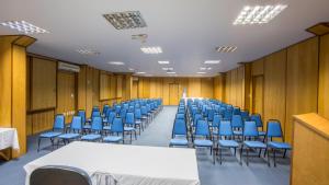 a conference room with blue chairs and tables in it at Atlântico Hotel in Santos