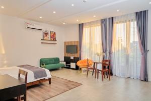 a hotel room with a bed and a table and chairs at Champion villa Hoi An in An Bang