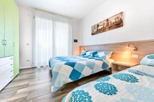 Postel nebo postele na pokoji v ubytování Jesolo Village Beach House - Host Solution