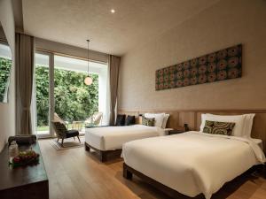 a bedroom with two beds and a living room at 西坡劳岭良室民宿 in Wukang +9 photos