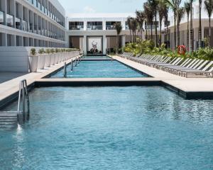 a swimming pool in front of a building at Platinum Yucatan Princess Adults Only - All Inclusive in Playa del Carmen