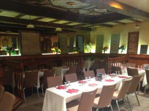 a dining room with white tables and chairs at Le Cheval Noir Hôtel Paris Pantin in Pantin