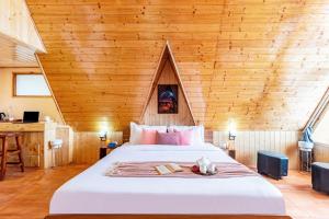 a bedroom with a bed with a wooden ceiling at SaffronStays Interstellar in Manāli