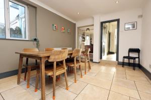 a dining room with a wooden table and chairs at Central Cardiff Victorian Town House Free parking in Cardiff +15 photos
