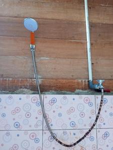a hose hooked up to a wall with a shower at Anno Homestay in Waisai
