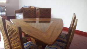 a wooden table with chairs and a dining room at Bungalos Las Esperanzas in Cabo Punta Banda