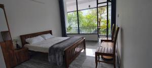 a bedroom with a bed and a large window at GMSquare in Thekkady +14 photos