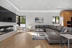 a living room with a couch and a fireplace at Heated Pool & Rooftop Near Intracoastal in Boynton Beach