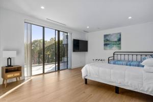 a bedroom with a bed and a large window at Heated Pool & Rooftop Near Intracoastal in Boynton Beach +61 photos