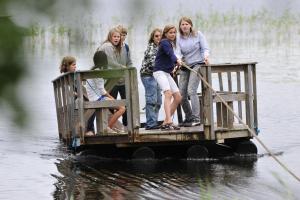 a group of people standing on a dock in the water at Hotel Rantakatti in Punkaharju