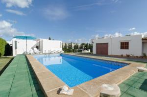a swimming pool in a villa with a house at Casa Fiol in Cala d´Or