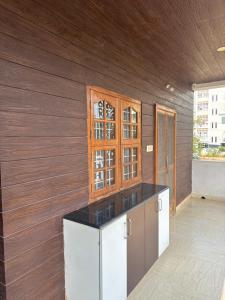 a kitchen with wooden walls and a counter top at Homestay in Kompally in Hyderabad