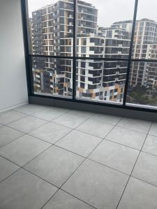 an empty room with a view of a city at 1 Bedroom Apartment with balcony in Sydney