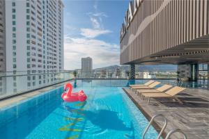 a swimming pool with a pink swan on the roof of a building at PANAMA Nha Trang Hotel in Nha Trang
