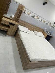 a large bed in a room with a mirror at Moony Hotel Long Thành in Long Thành